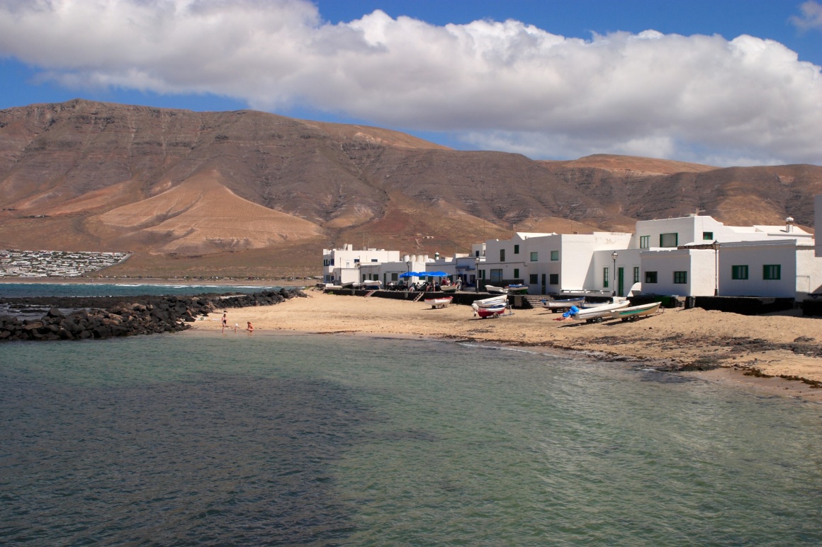 'Spain Canary Islands Lanzarote village of whitewashed houses overlooking Famara Beach' - Lanzarote